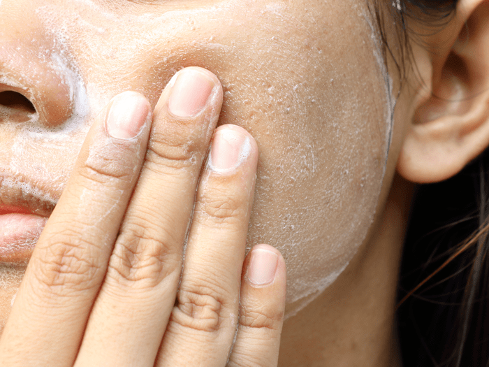woman washing face with facewash