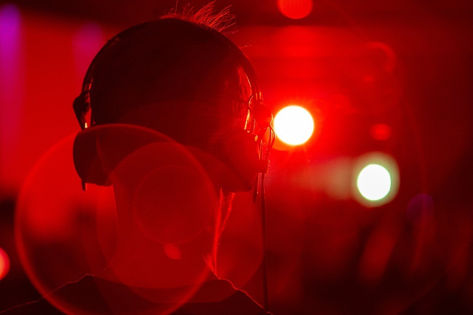 boy with headphone in front of red light