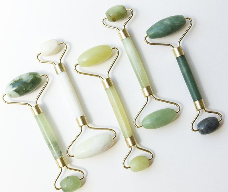 multiple jade rollers on white background