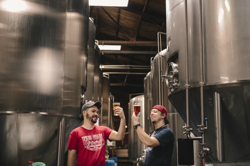 Two friends in a beer production factory