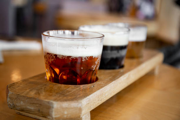 Three glasses with different types of beer on a table in a bar, photo with soft focus. High quality photo