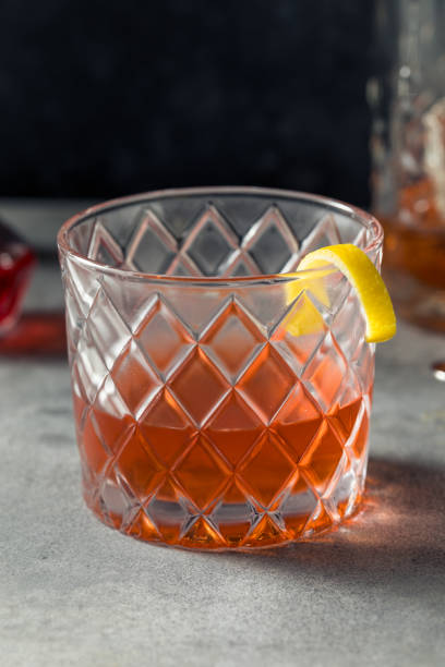 Boozy Refreshing Rye Whiskey Sazerac Cocktail with a Lemon Garnish