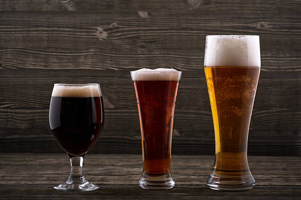 Various types of beer on a wooden background